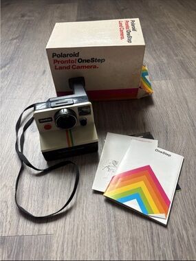 Polaroid OneStep Land Camera — cream body with rainbow stripe